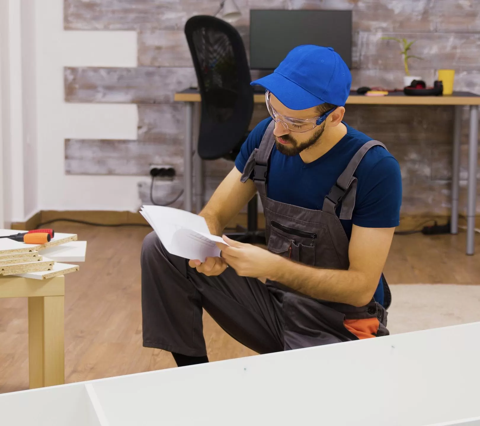 male-worker-wearing-protection-glasses-before-furniture-assembly