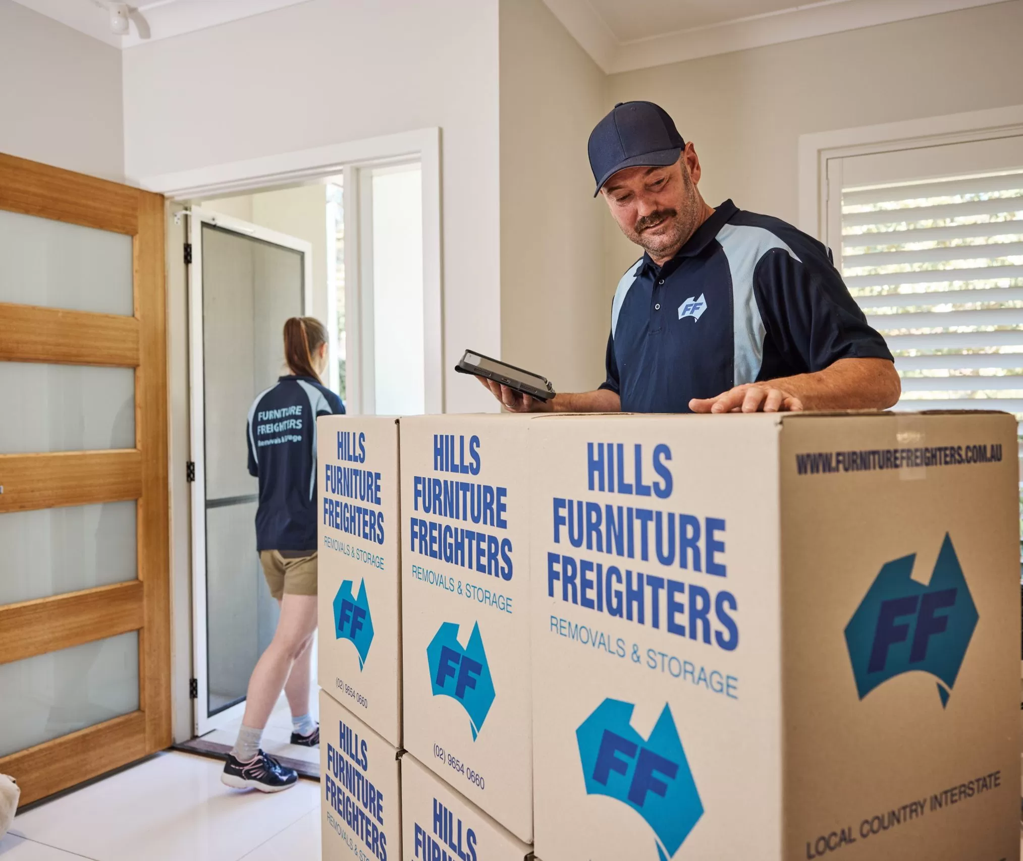Furniture Freighters Holding a Calculator